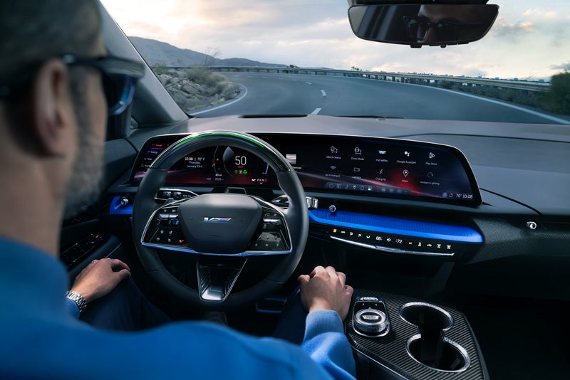 Front View of the 2026 OPTIQ-V Driving Through the Dusk Utilizing its Headlights | Carl Cannon Chevrolet Buick GMC in Jasper AL
