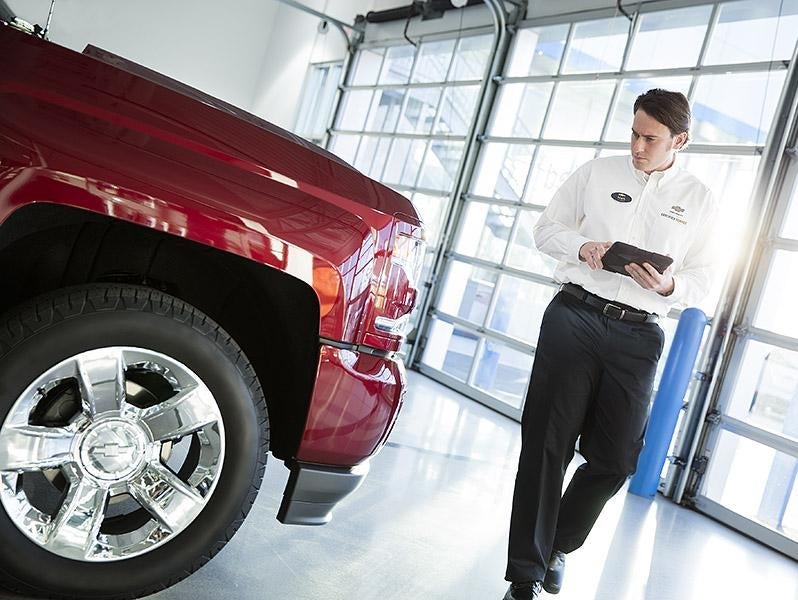 Technician Inspecting Vehicle