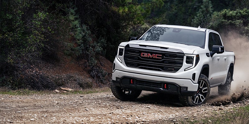 A 2020 GMC Sierra 1500 navigating a rugged dirt road