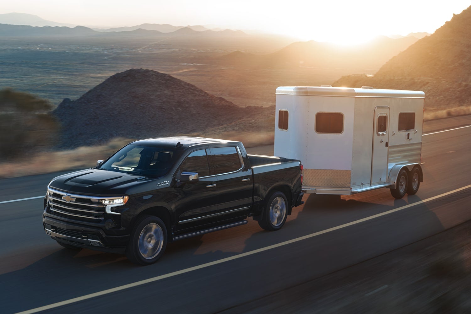 A Chevy Silverado 1500 towing in a mountainous setting