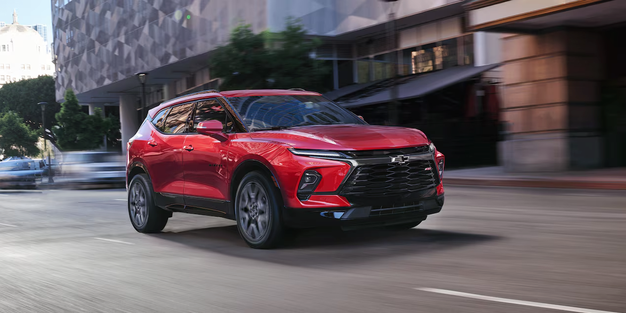 Front and side view of a 2026 Chevy Blazer in red on a city street