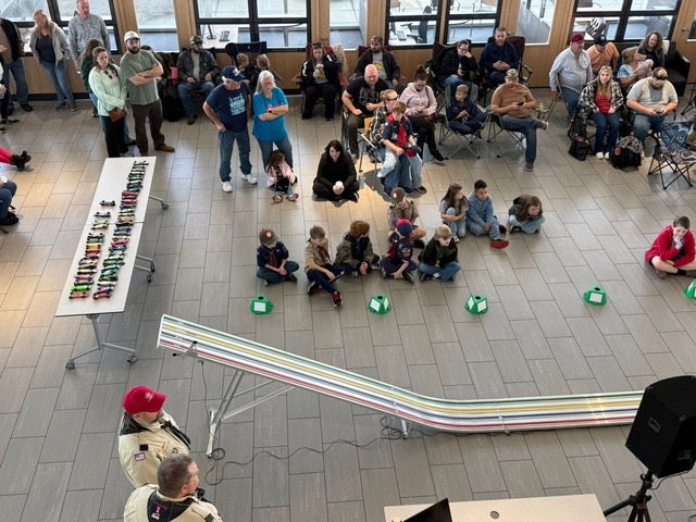A black Boy Scout participating in the annual Pine Wood Derby