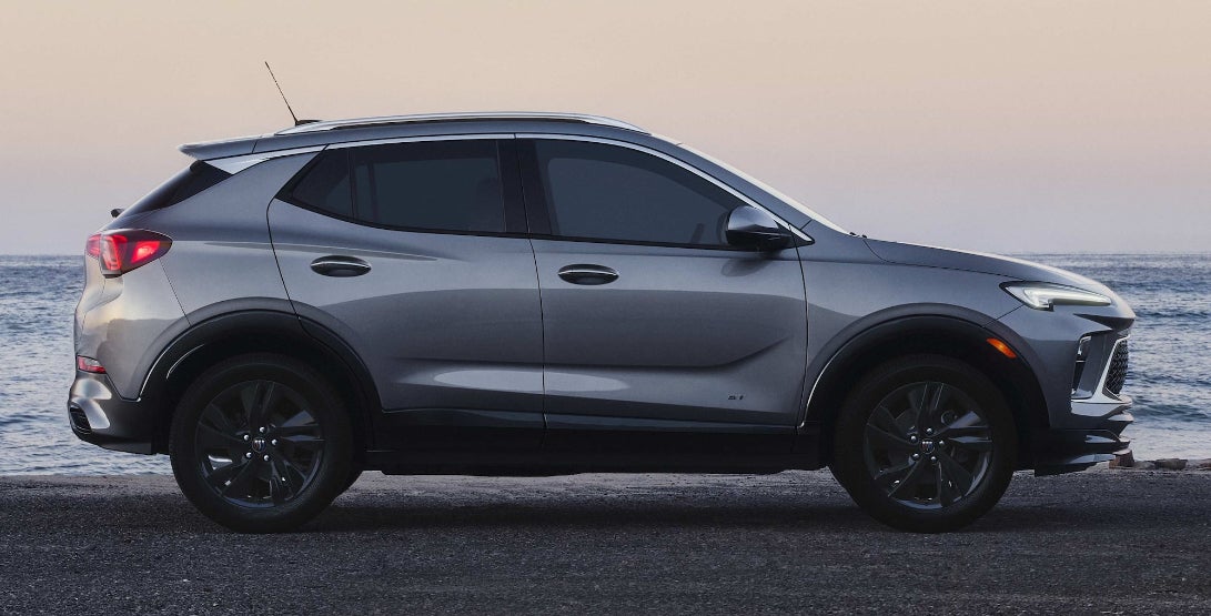 A gray Buick Encore GX in profile on a beach head.