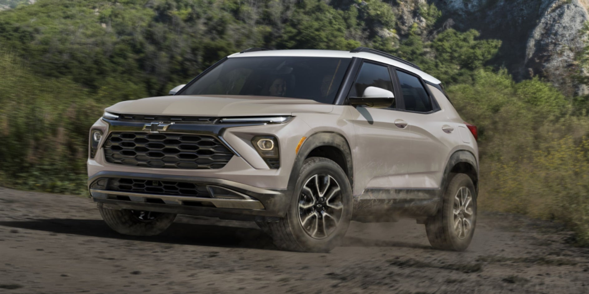 A sand-colored Chevy Trailblazer driving off-road.